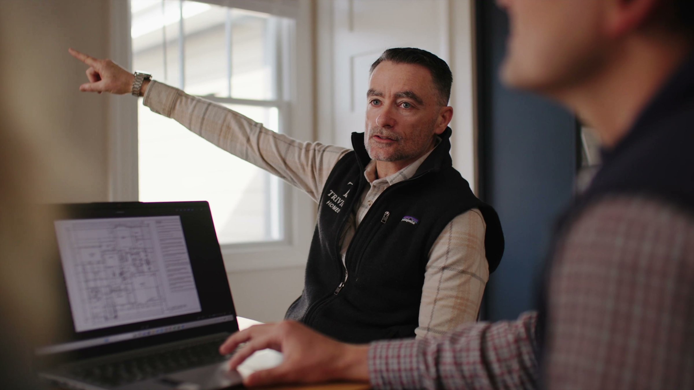 Trivium Homes owner reviewing floor plans with a client